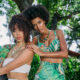 Photo of models wearing conch pearl and emerald jewelry by Emeralds International LLC.