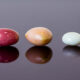 A variety of conch pearl colors, shapes and sizes in a line.