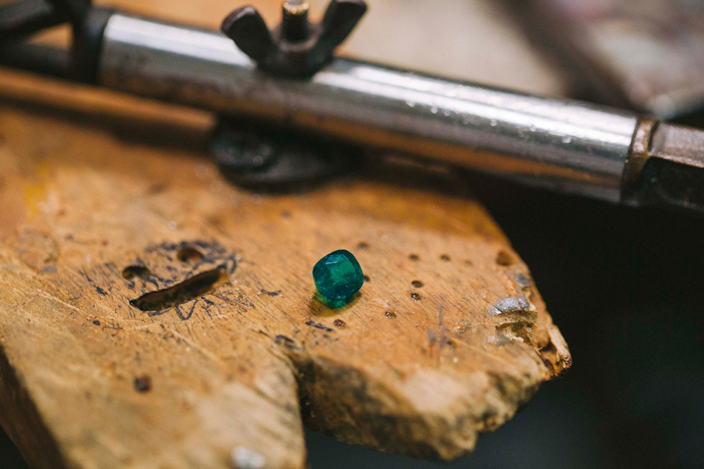 Colombian emerald on a jewelers work bench.
