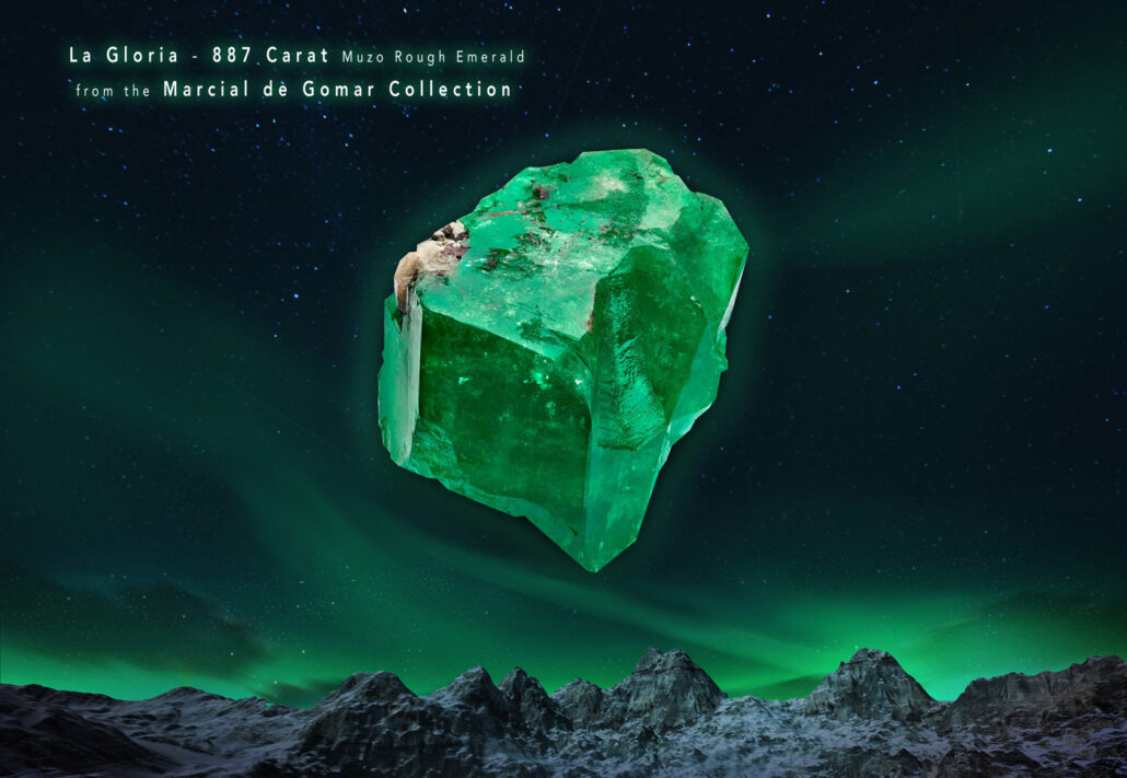 Photo of La Gloria rough emerald floating in the night sky with northern lights and mountains. Includes text saying "La Gloria - 887 Carat Muzo Rough Emerald from the Marcial de Gomar Collection.