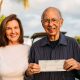 Inge and Manuel Marcial holding a check from the first sale of the Tears of Fura book by Manuel.