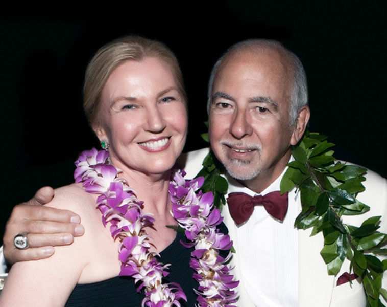 Photo of Inge and Manuel Marcial wearing leis.