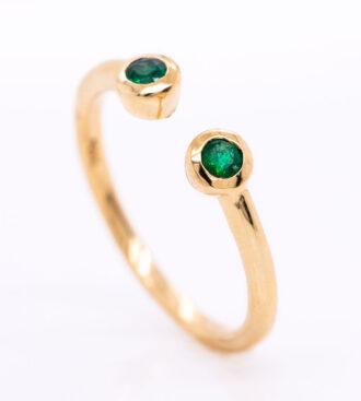 Emerald U-Bar Ring on a white background.