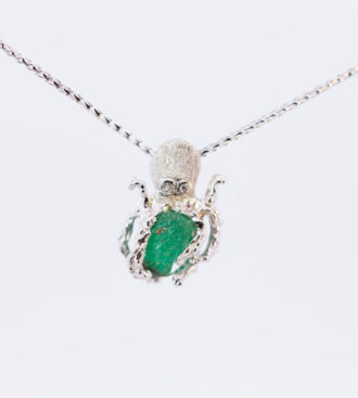 A rough emerald octopus pendant