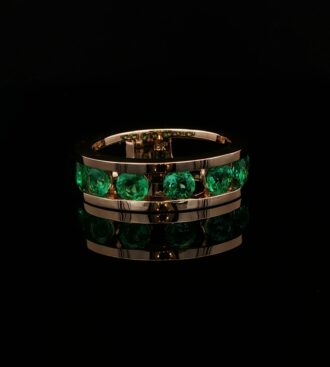 Round emerald channel set band ring
